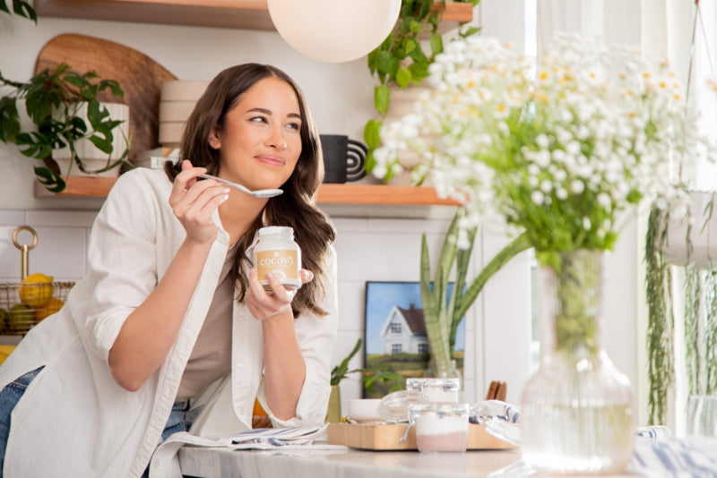 Woman enjoying GT's COCOYO Living Coconut Yogurt